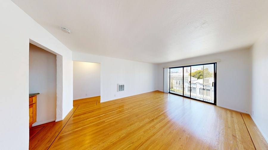 A room with wooden floors and white walls.